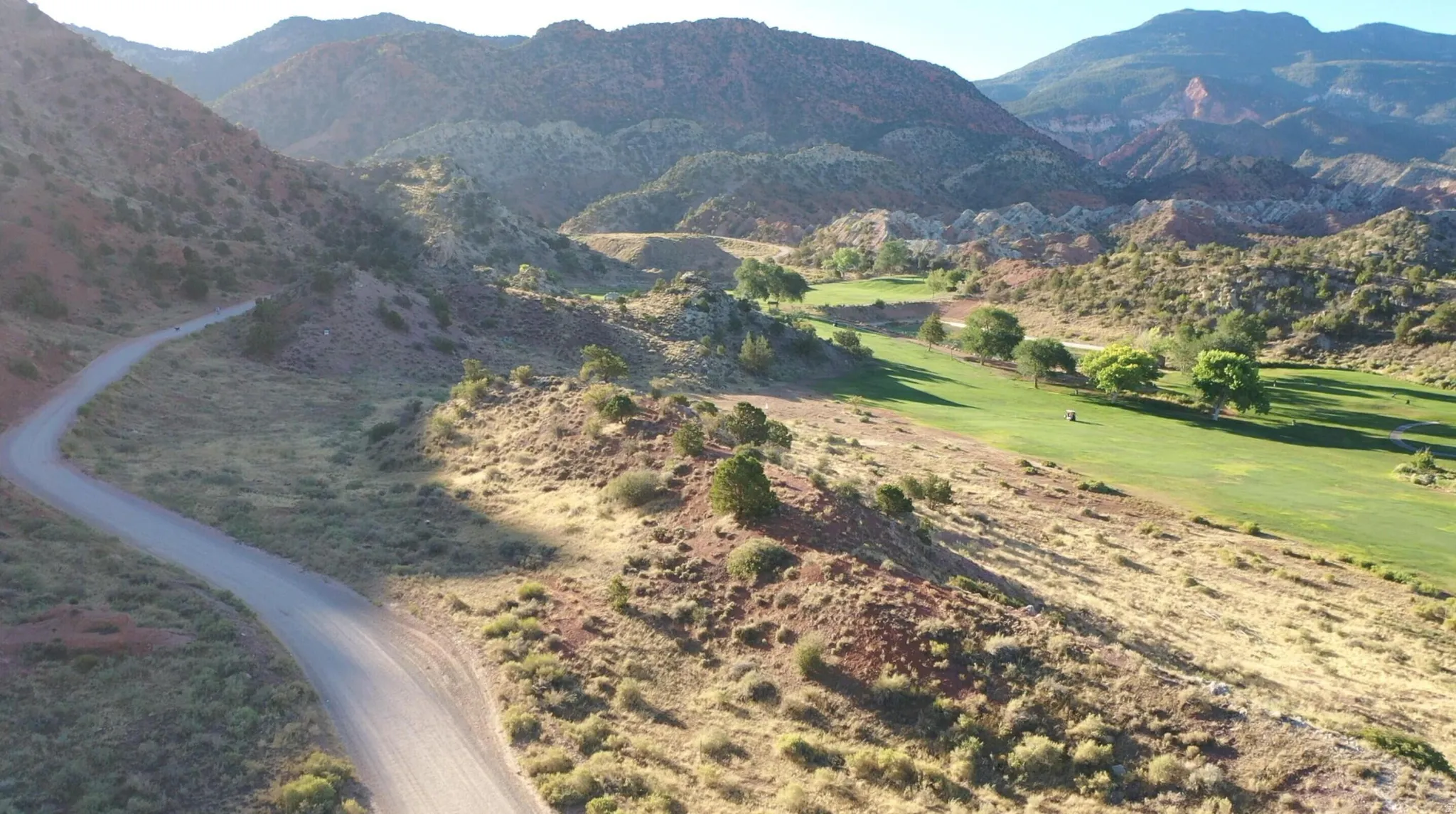 View of mountain background featuring a local golf course