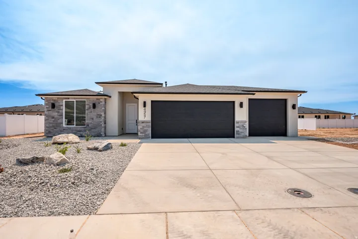 Contemporary facade featuring a light-colored stucco finish and gray stone veneer accents