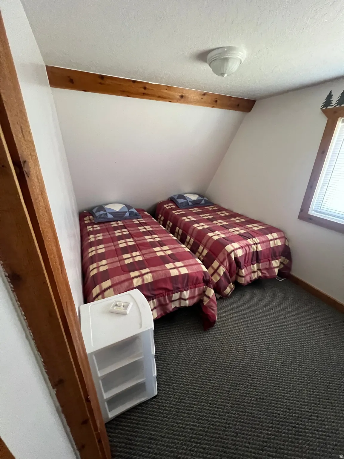 Bedroom #2 featuring carpet flooring and beam ceiling