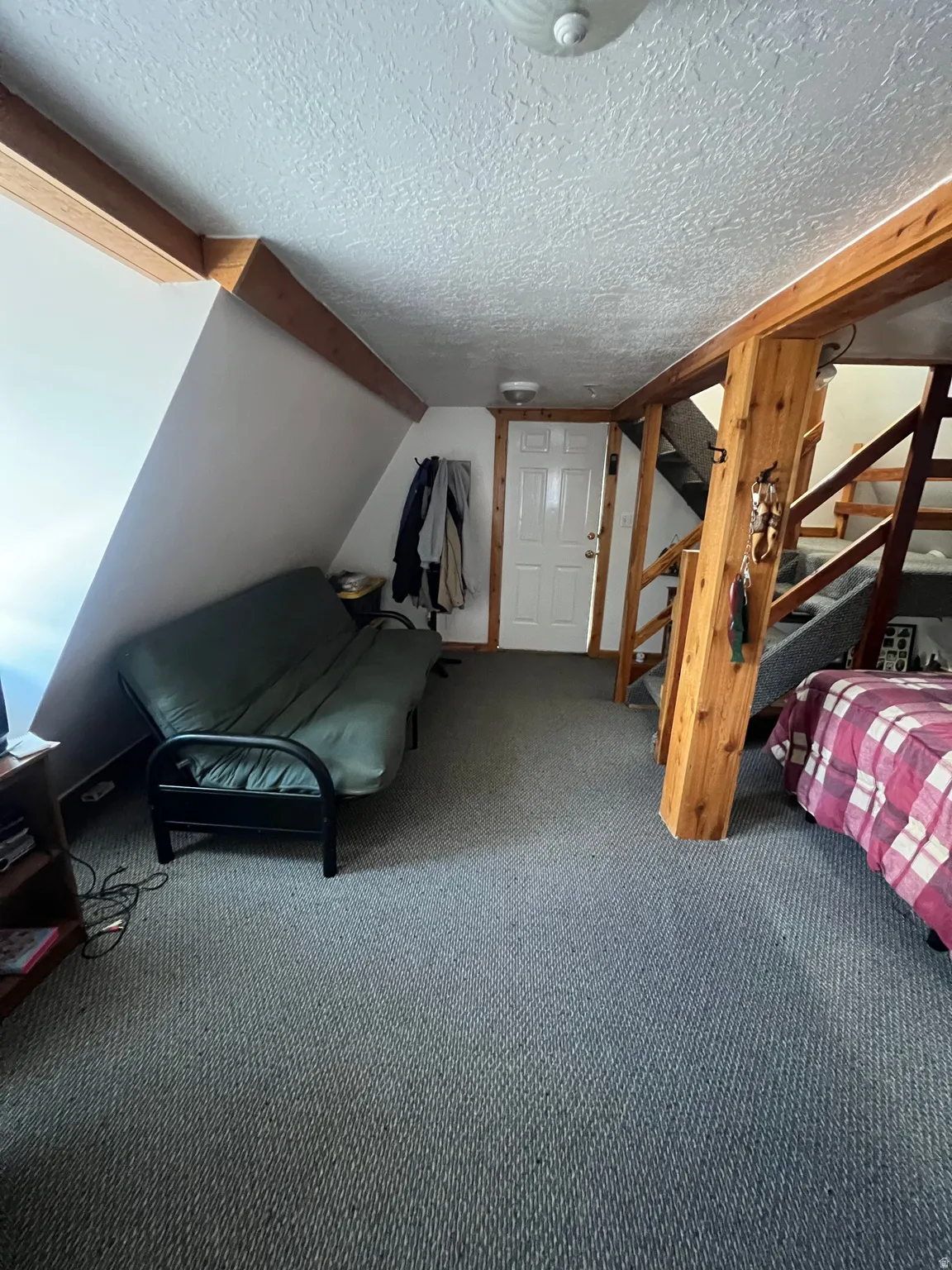 Bedroom #1 with a textured ceiling and carpet floors