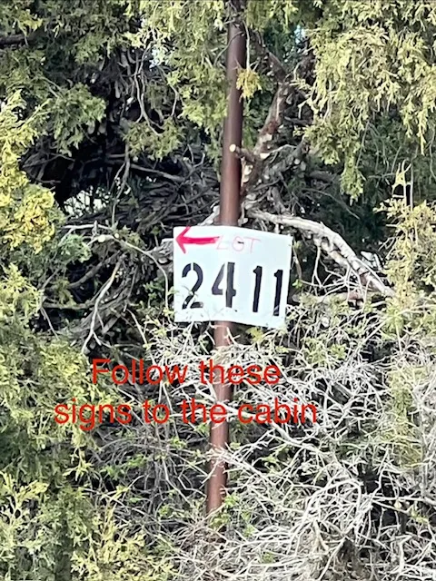 The lot number is located 50 yrds East from first gate. Follow these signs to the cabin.