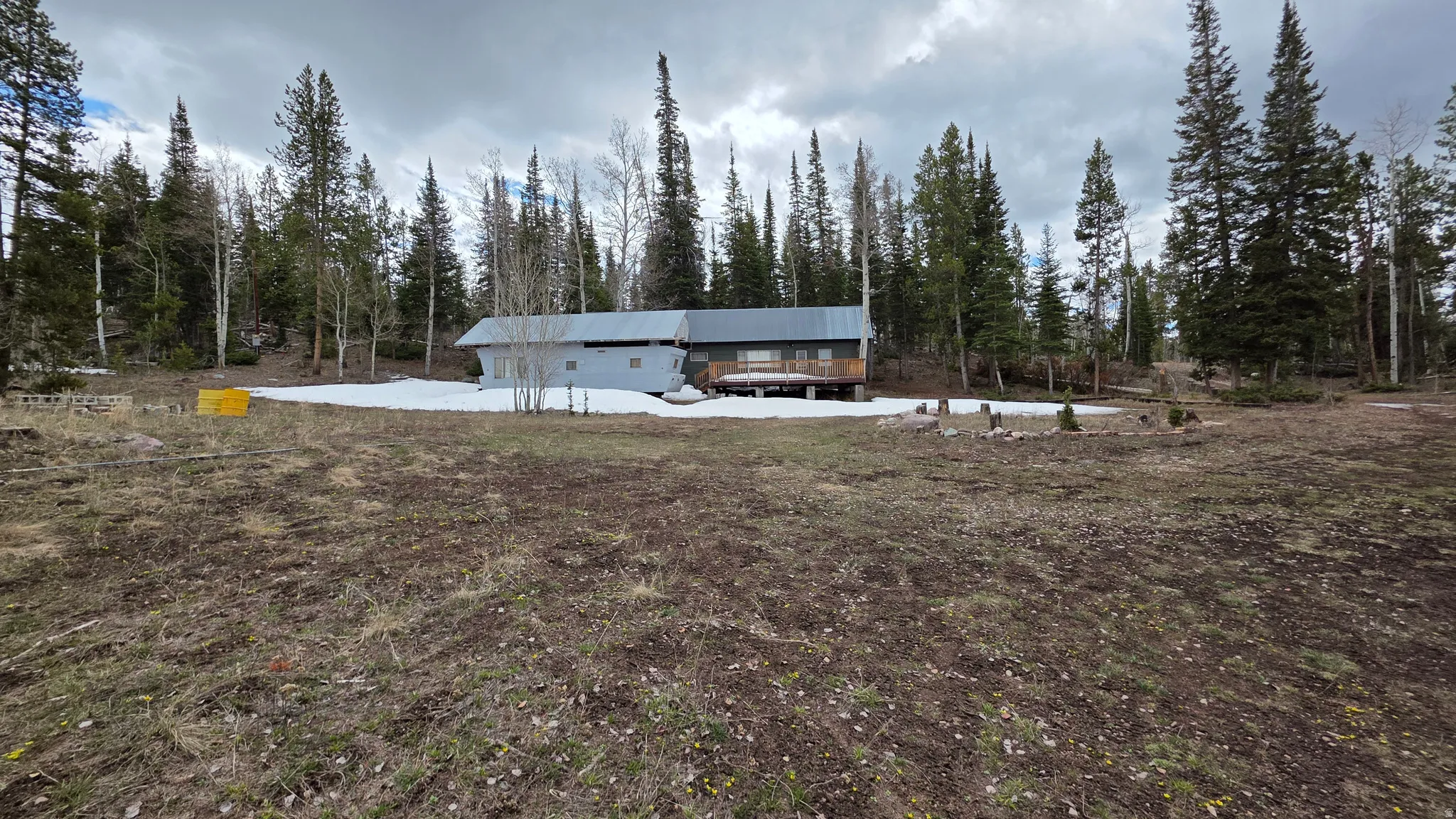 View of front of house with view of scattered trees