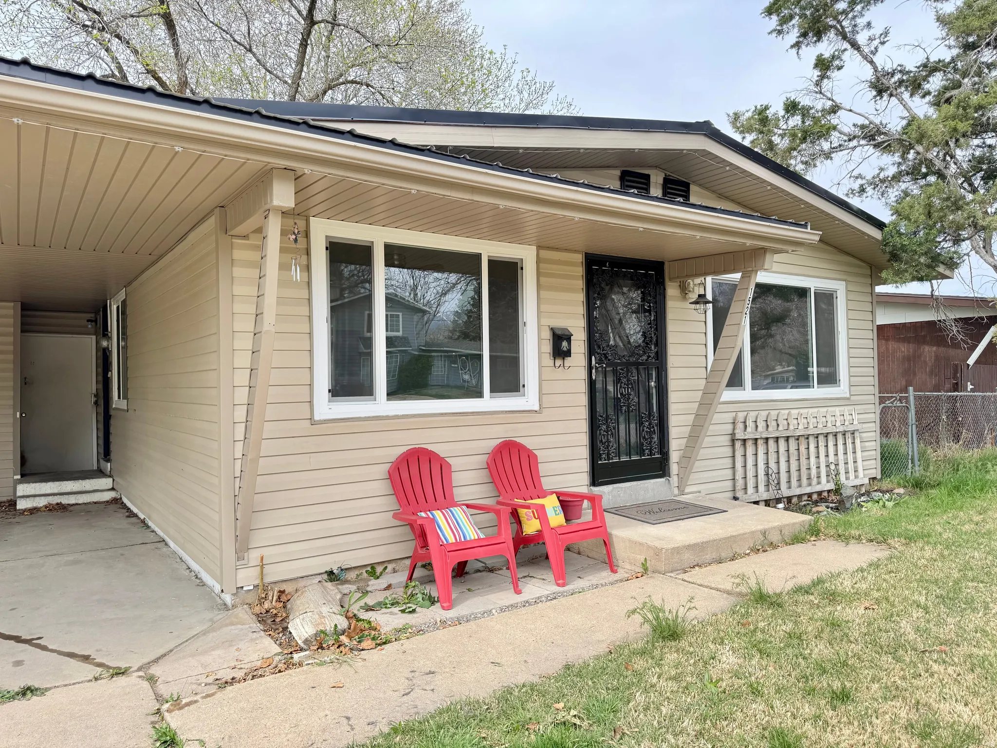 Doorway to property with a carport