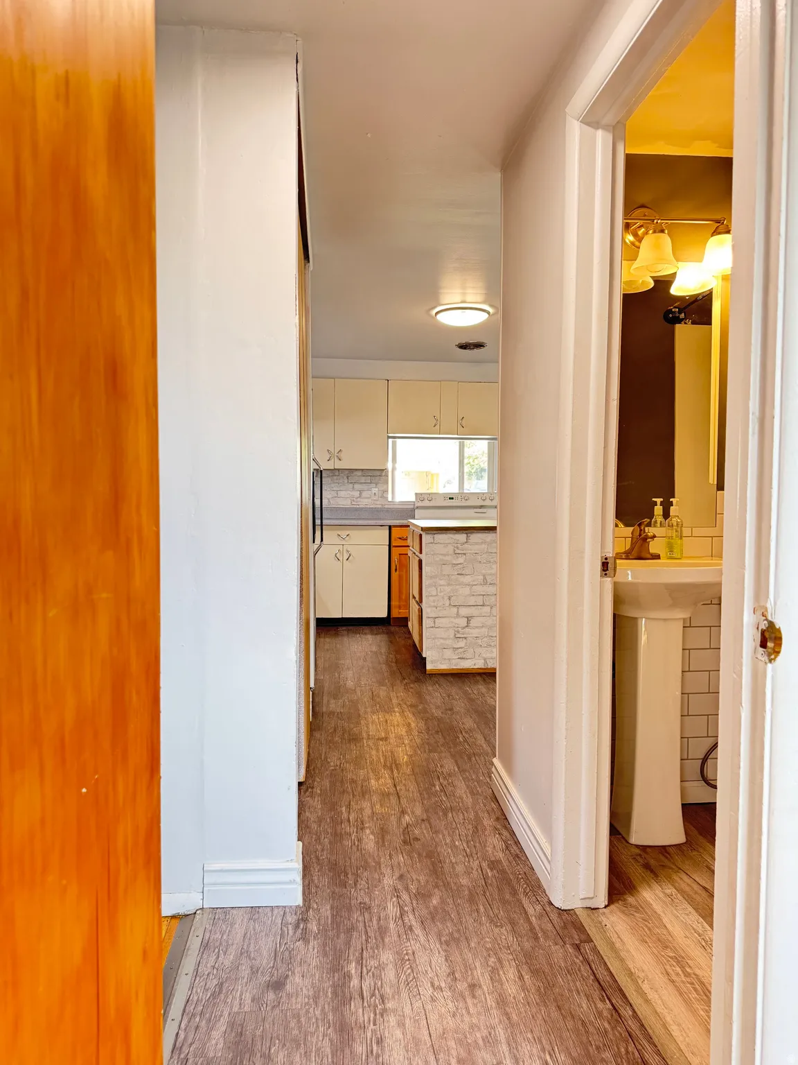 Corridor featuring dark wood-type flooring and baseboards