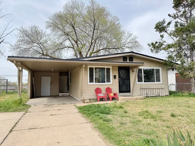 View of front of house with an attached carport, concrete driveway, and covered porch