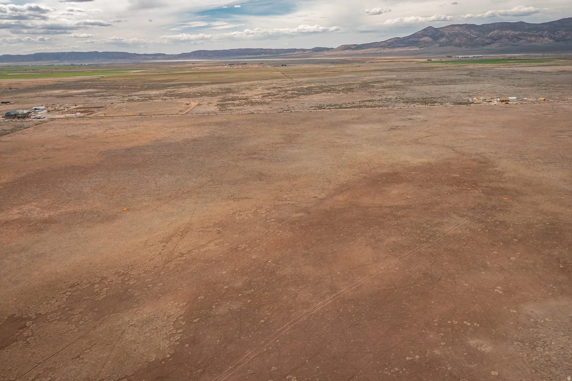 View of mountain backdrop with rural landscape