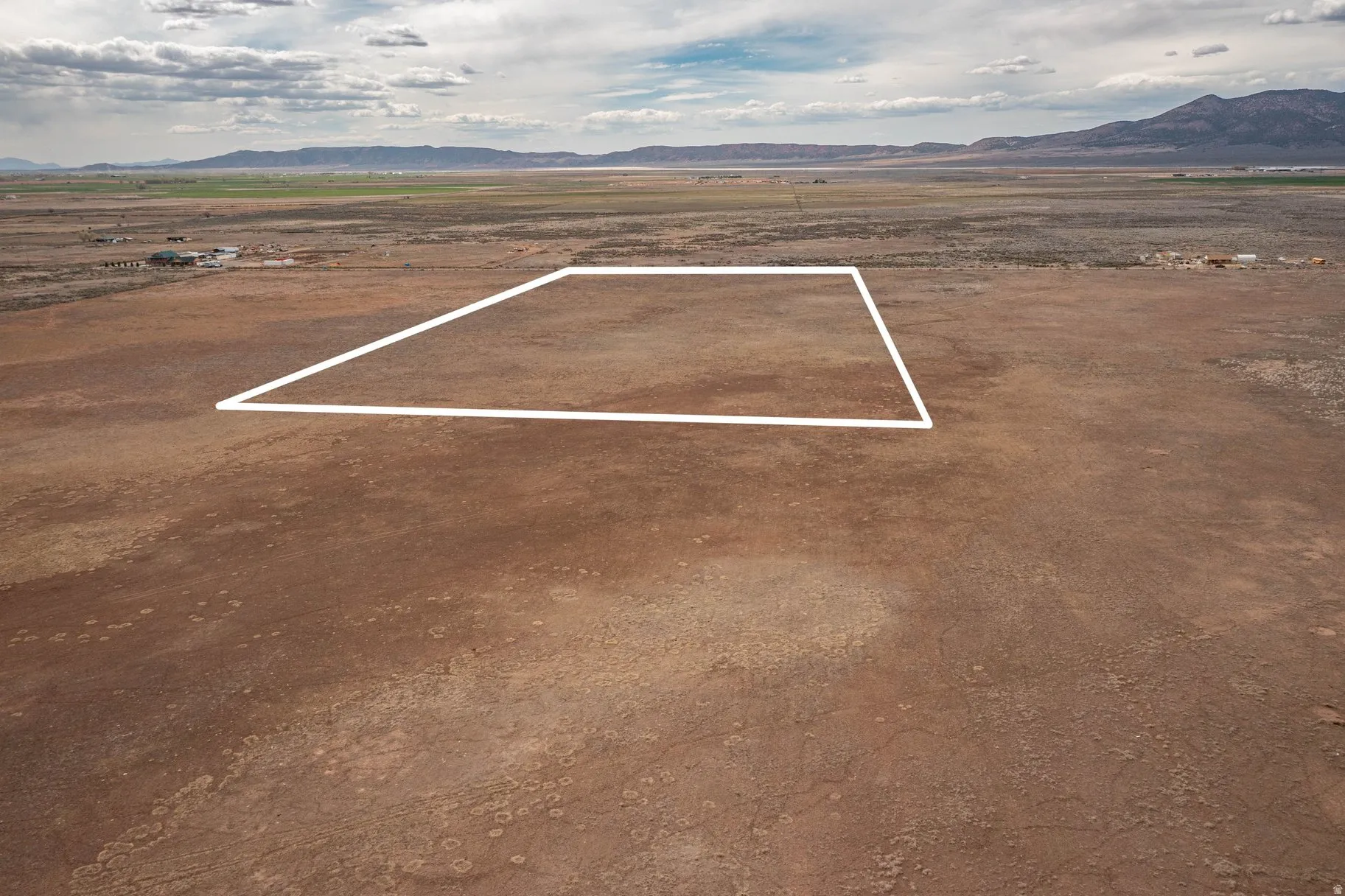 View of rural area with a mountain backdrop and property boundaries highlighted