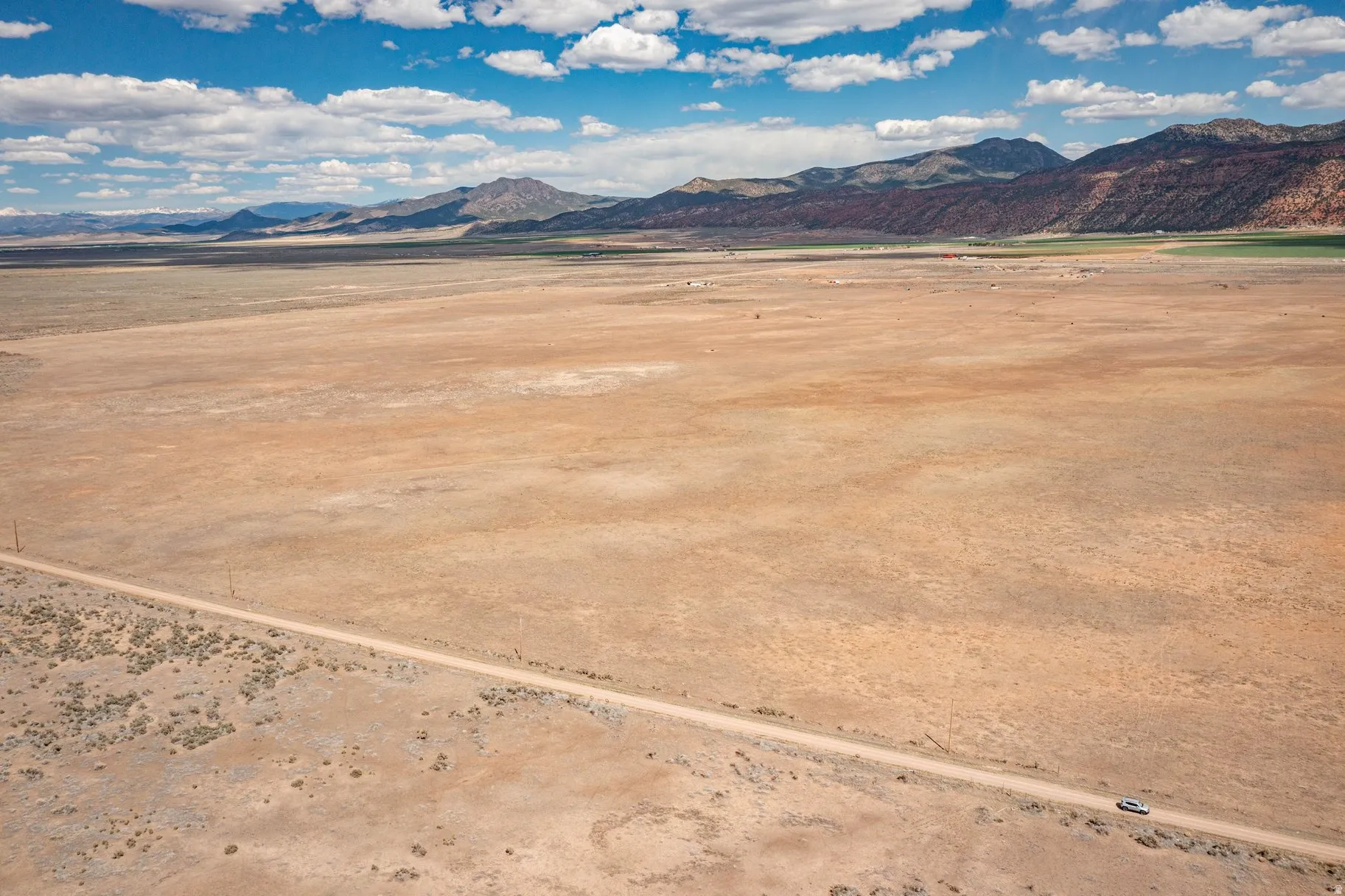 View of mountain backdrop with a desert landscape and rural landscape