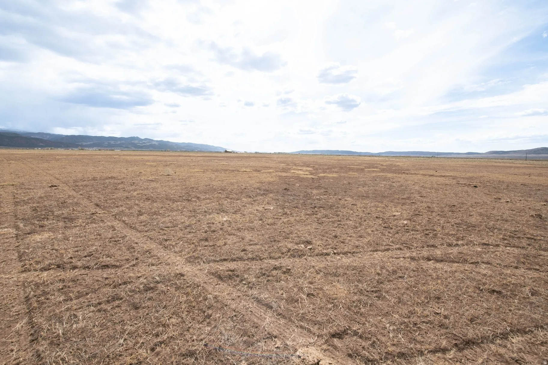 View of yard with a rural view and a mountain view