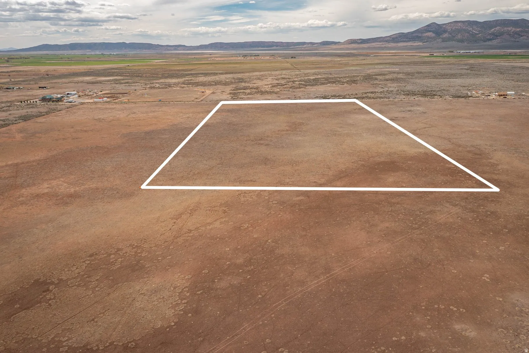 View of rural area with a mountain backdrop and property parcel outlined
