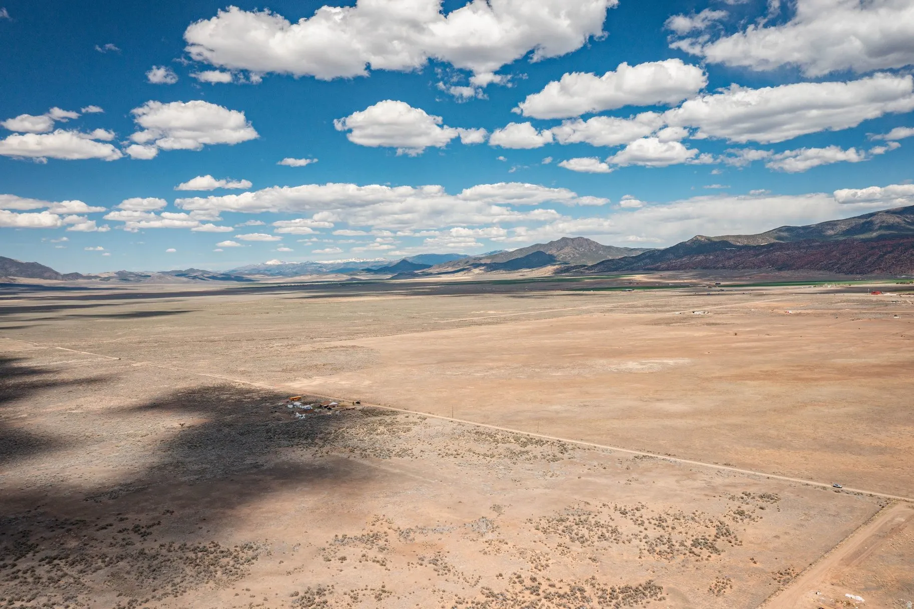 View of mountain backdrop with a desert landscape and rural landscape