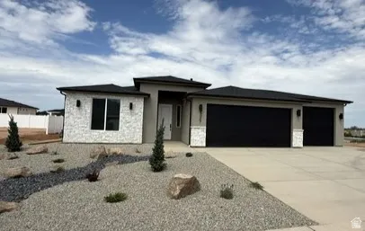 Contemporary single-story residence featuring a stucco and stone veneer exterior