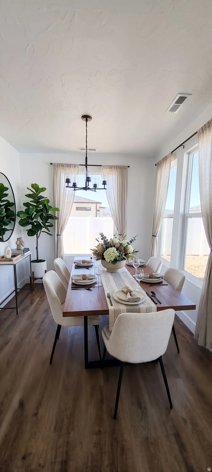 Ai Stage. Wood-finish flooring, multiple large windows, contemporary chandelier, white walls, and a built-in console table