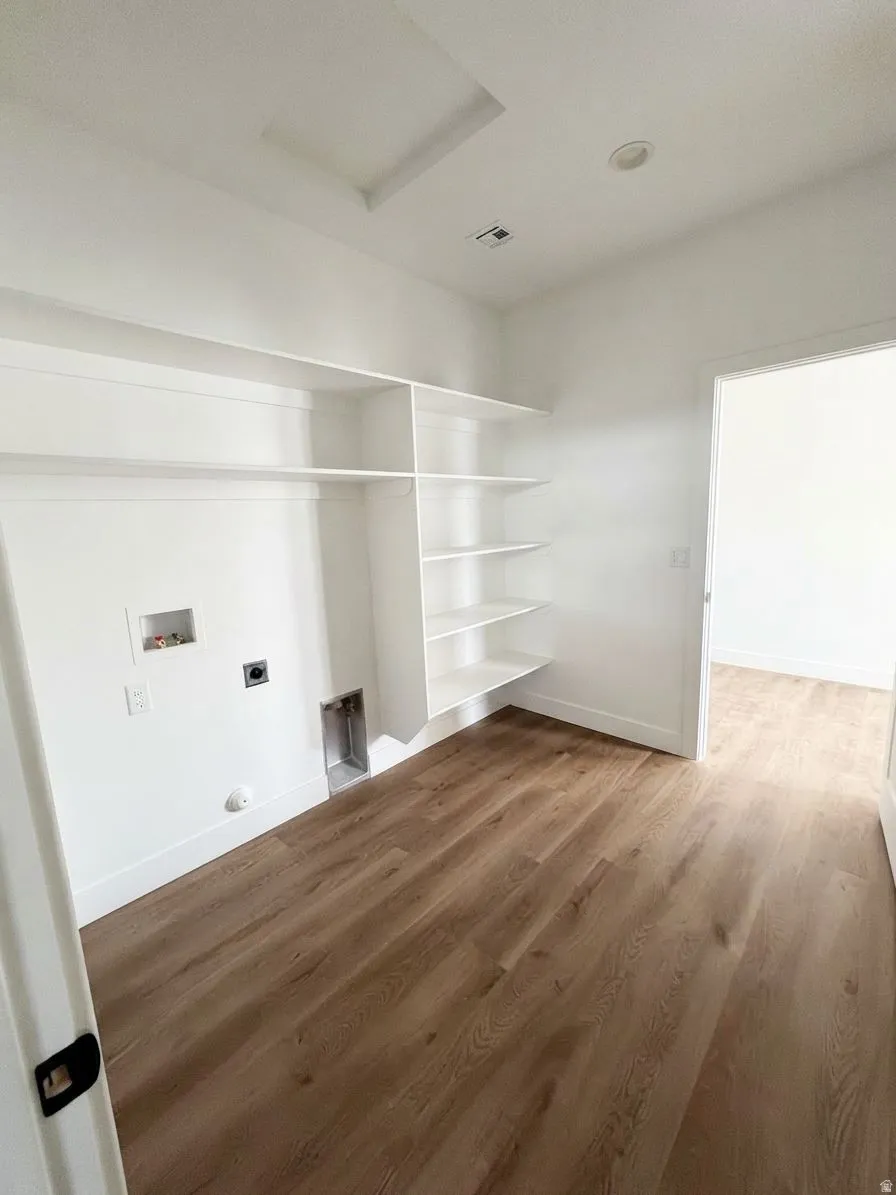 Wood-finish flooring, built-in shelving, laundry hookups, and recessed lighting