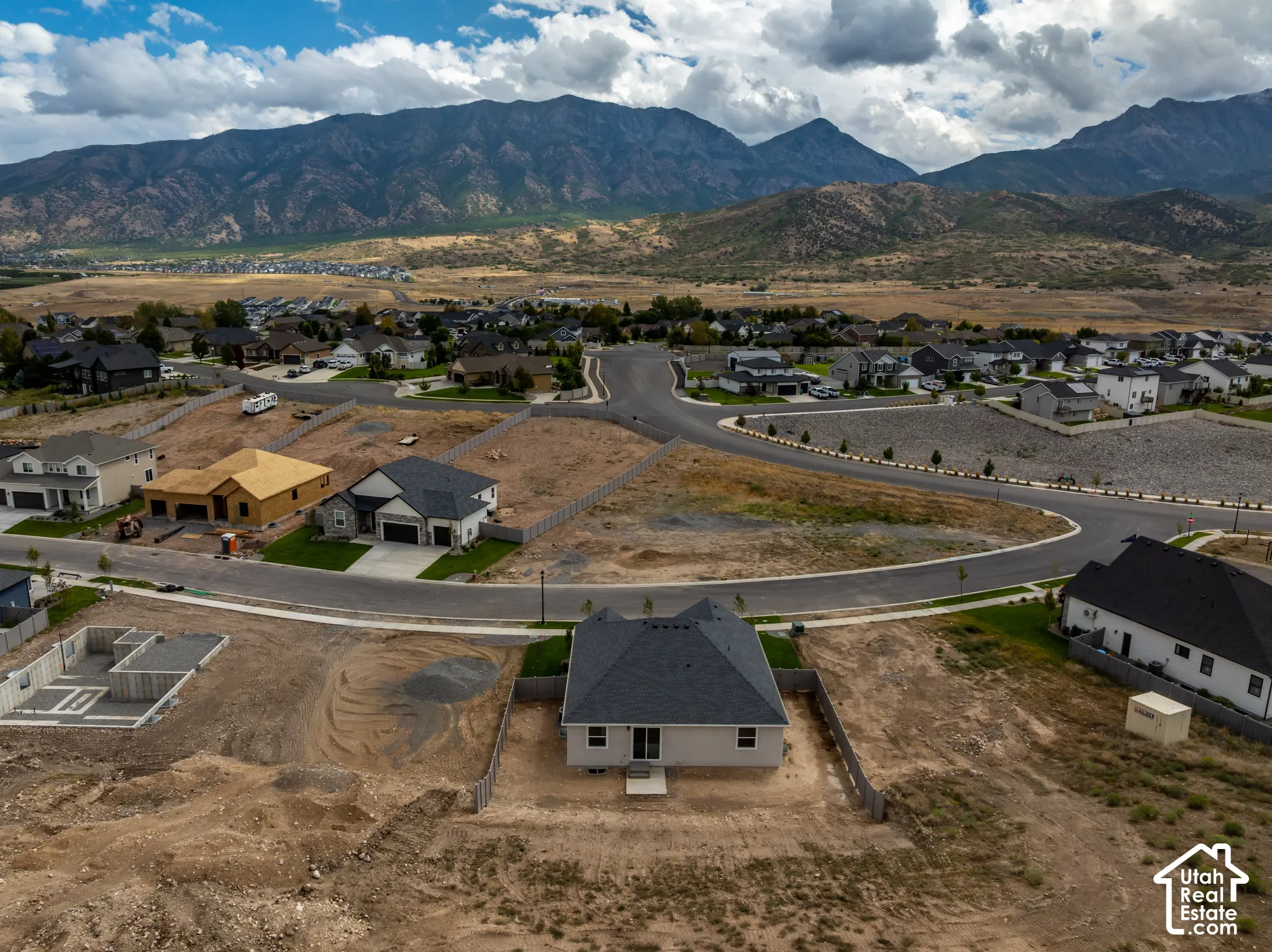 Mountain scenery, developing residential area, paved streets, new construction, graded lots