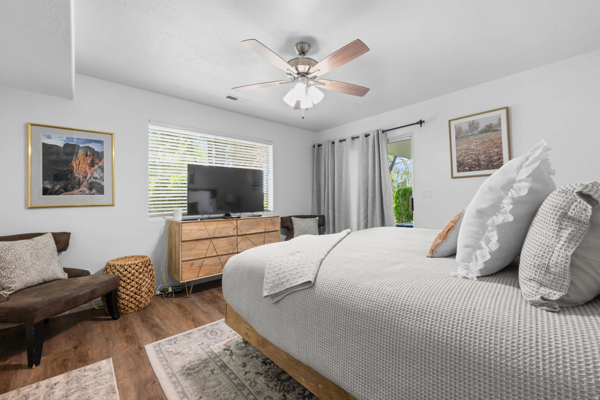 Bedroom with dark wood-style flooring and a ceiling fan