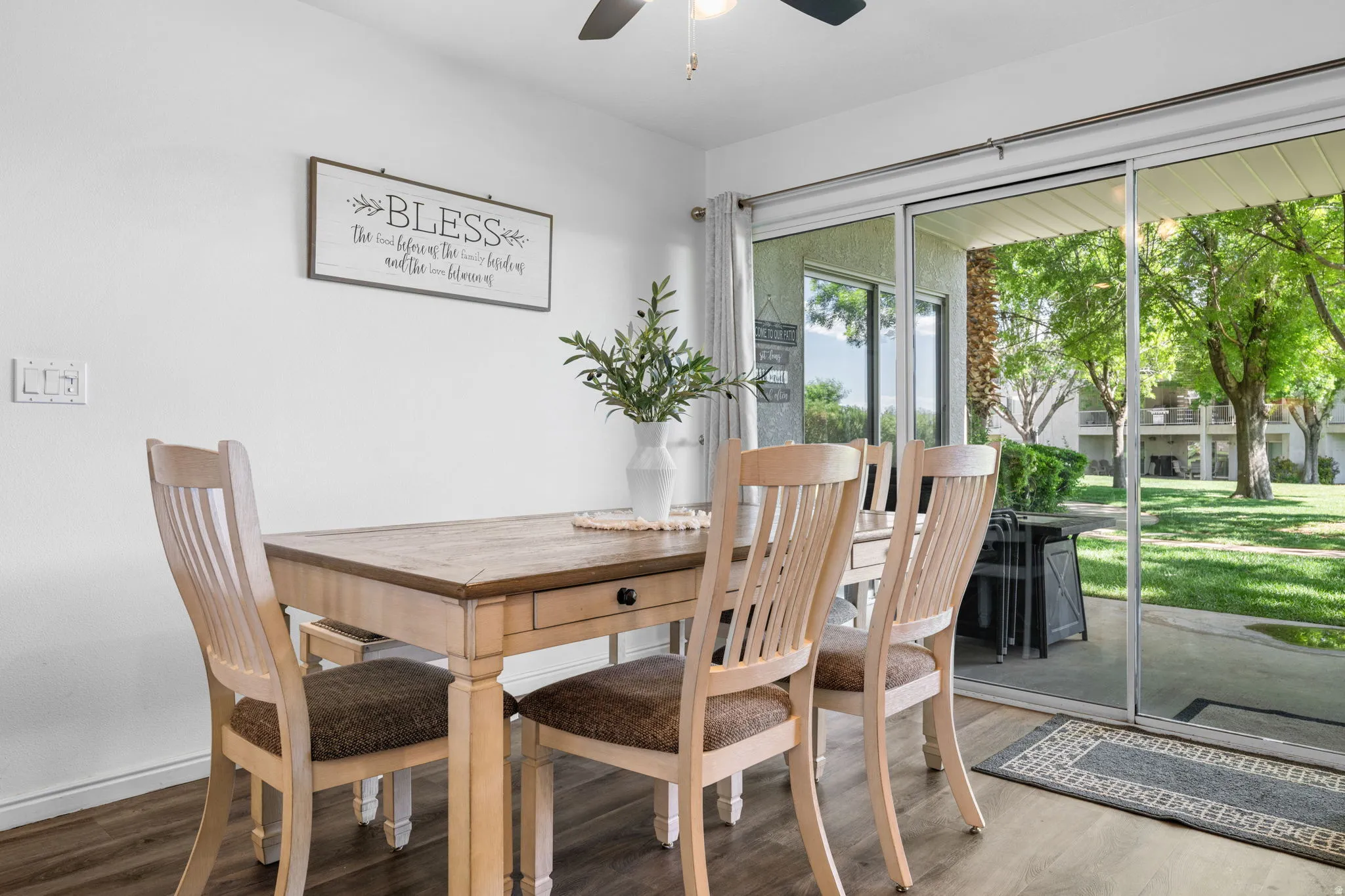 Dining area with wood finished floors and a ceiling fan