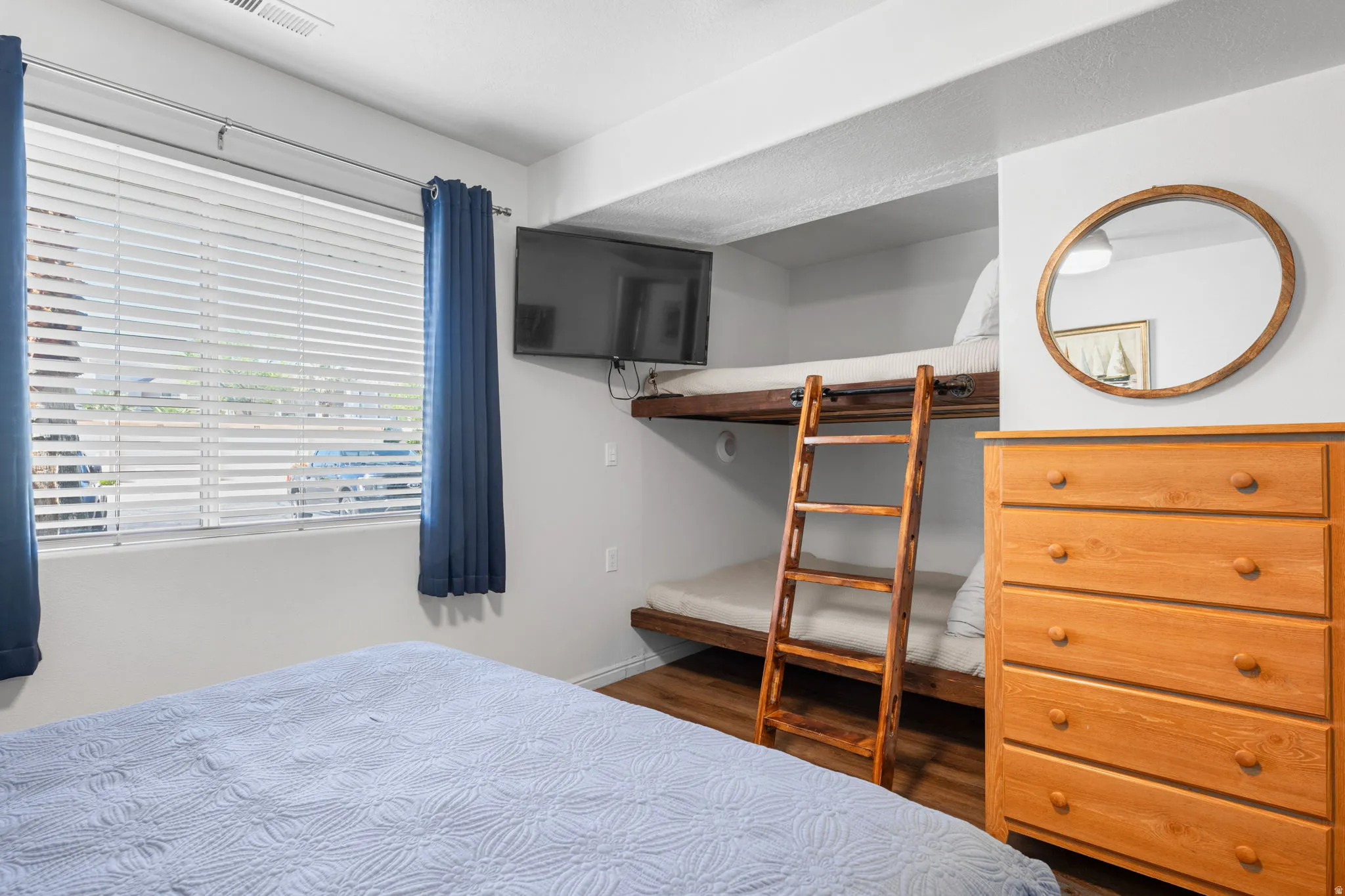 Bedroom with baseboards and dark wood-type flooring
