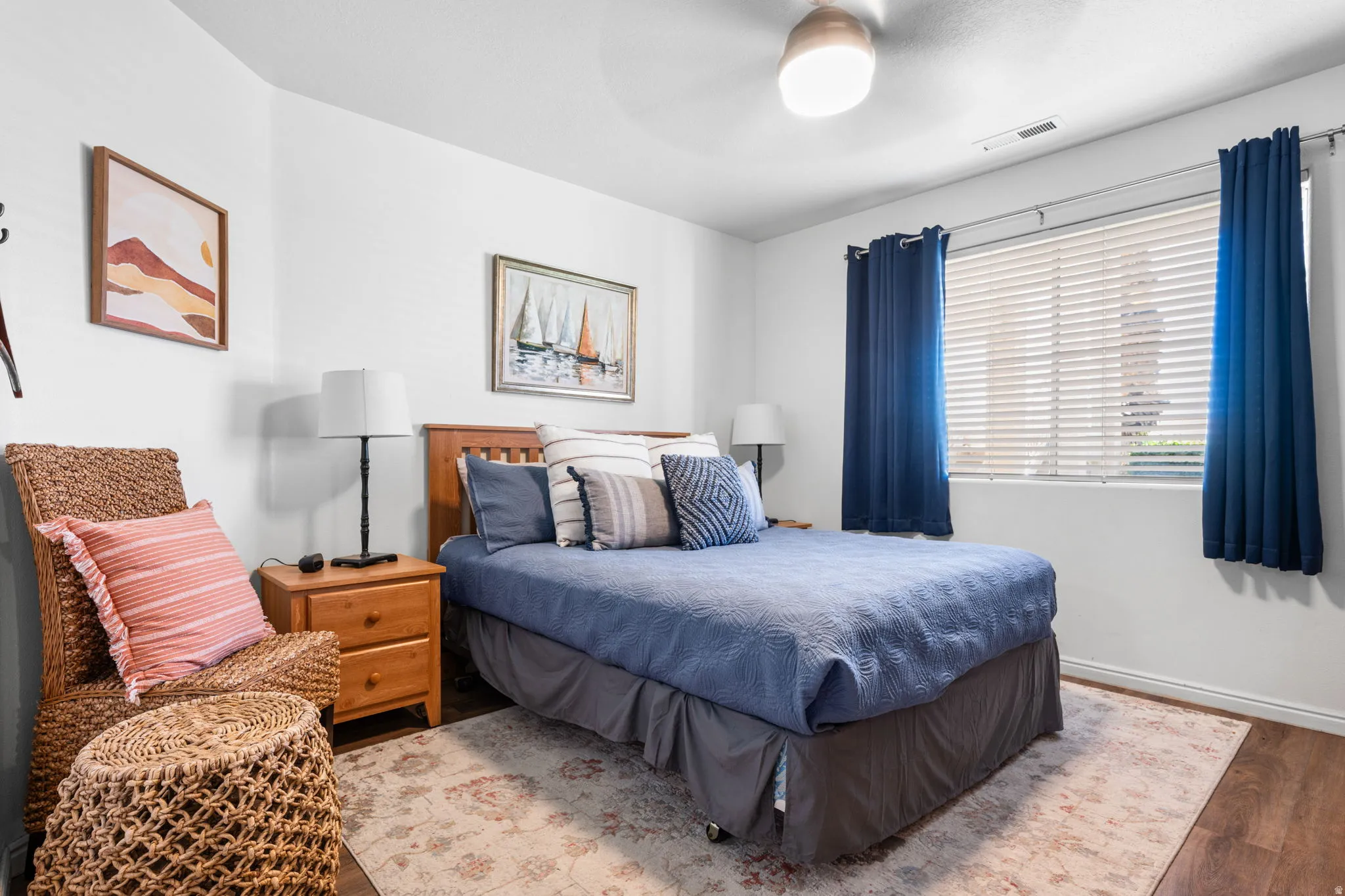 Bedroom with wood finished floors and ceiling fan