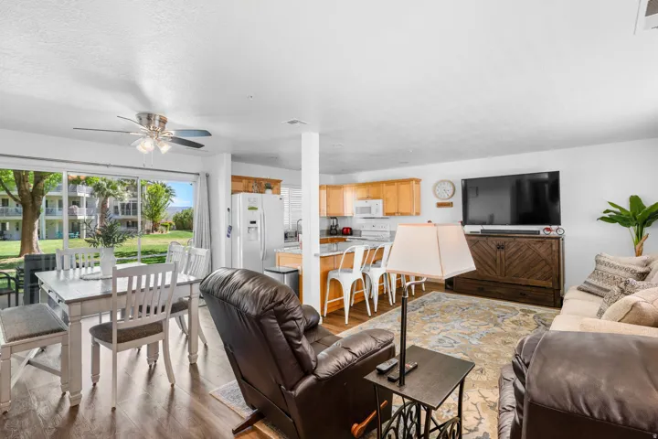 Living room with light wood finished floors and ceiling fan