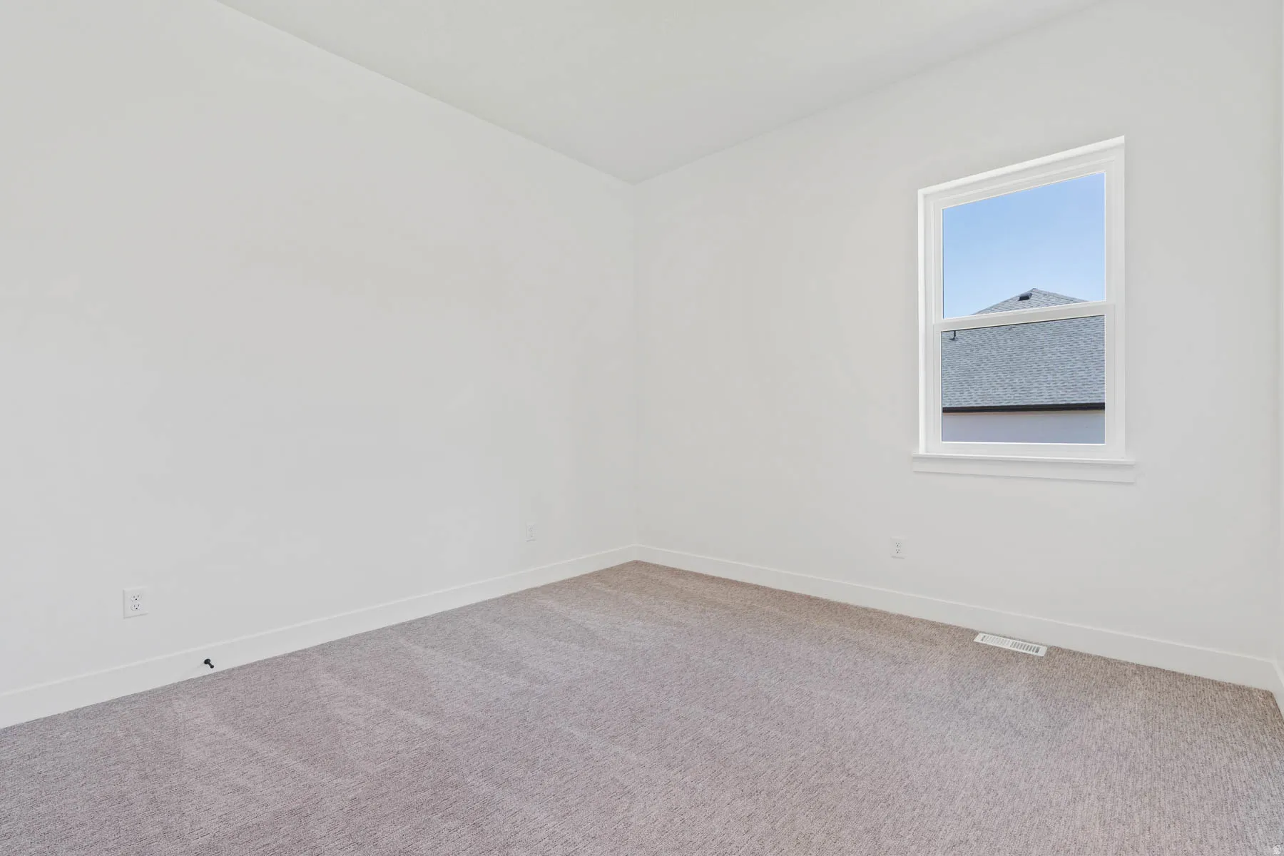 Spare room with carpet floors and baseboards