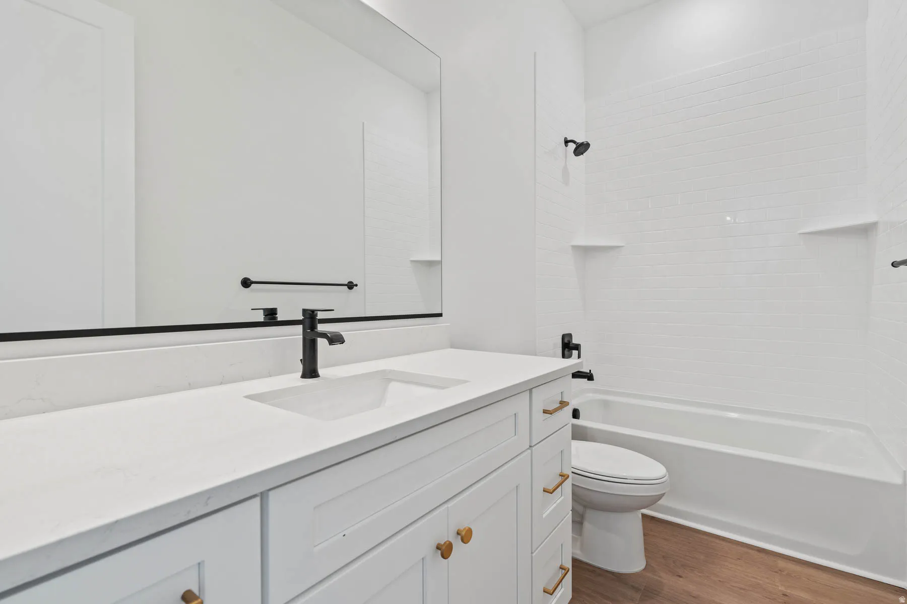 Full bath with vanity, dark wood-style flooring, and bathtub / shower combination