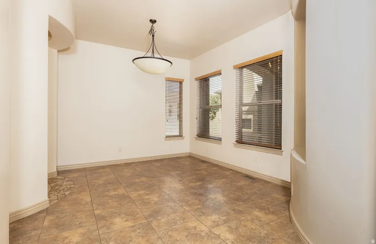 Empty room featuring baseboards