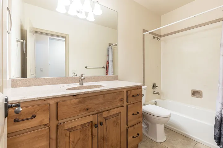 Bathroom featuring vanity, light tile patterned floors, and shower / bath combo