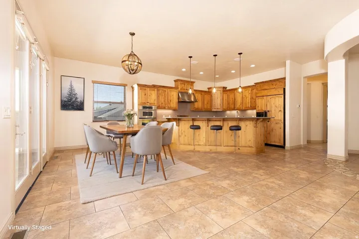 Dining space featuring baseboards and a chandelier