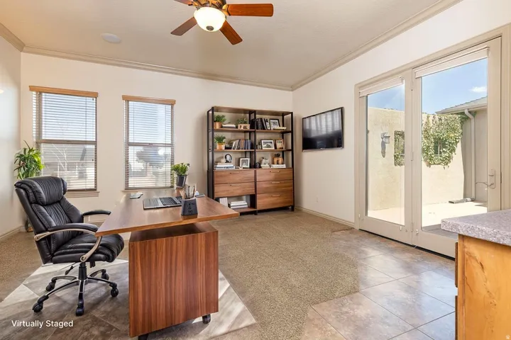 Office featuring a ceiling fan, healthy amount of natural light, ornamental molding, and light tile patterned floors