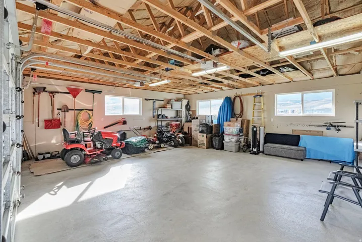 Oversized garage offers room for vehicles, toys, and extra gathering space—perfect for game nights, casual meals, and winding down after an evening around the campfire.
