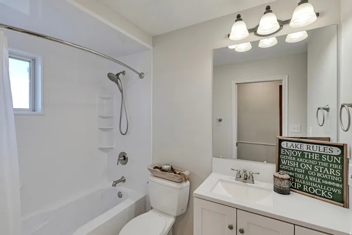 Newly remodeld full bath featuring vanity and shower / bath combination with pocket door.