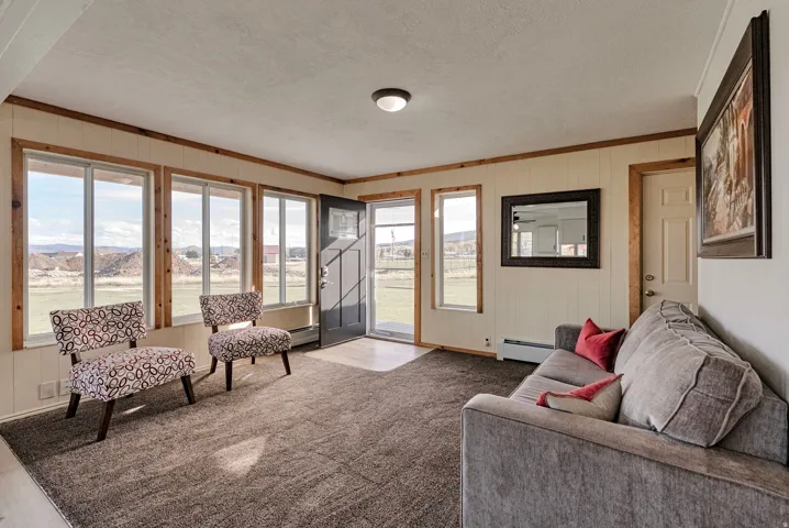 The home features an open living area filled with natural light, an updated kitchen.