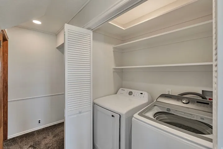 Laundry area featuring washing machine and dryer, dark carpet, and recessed lighting