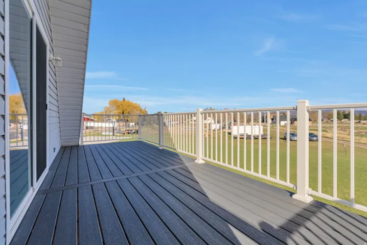 Whether you're watching a backyard game, enjoying a summer evening, or gathering with family after a day at the lake, the upper deck offers a natural place to relax and make memories together.