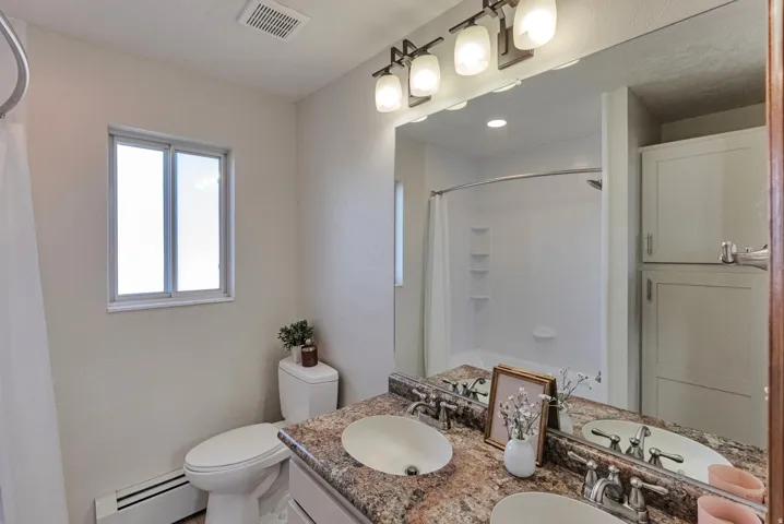 Bathroom with double vanity, large linen closet and new bath/shower.