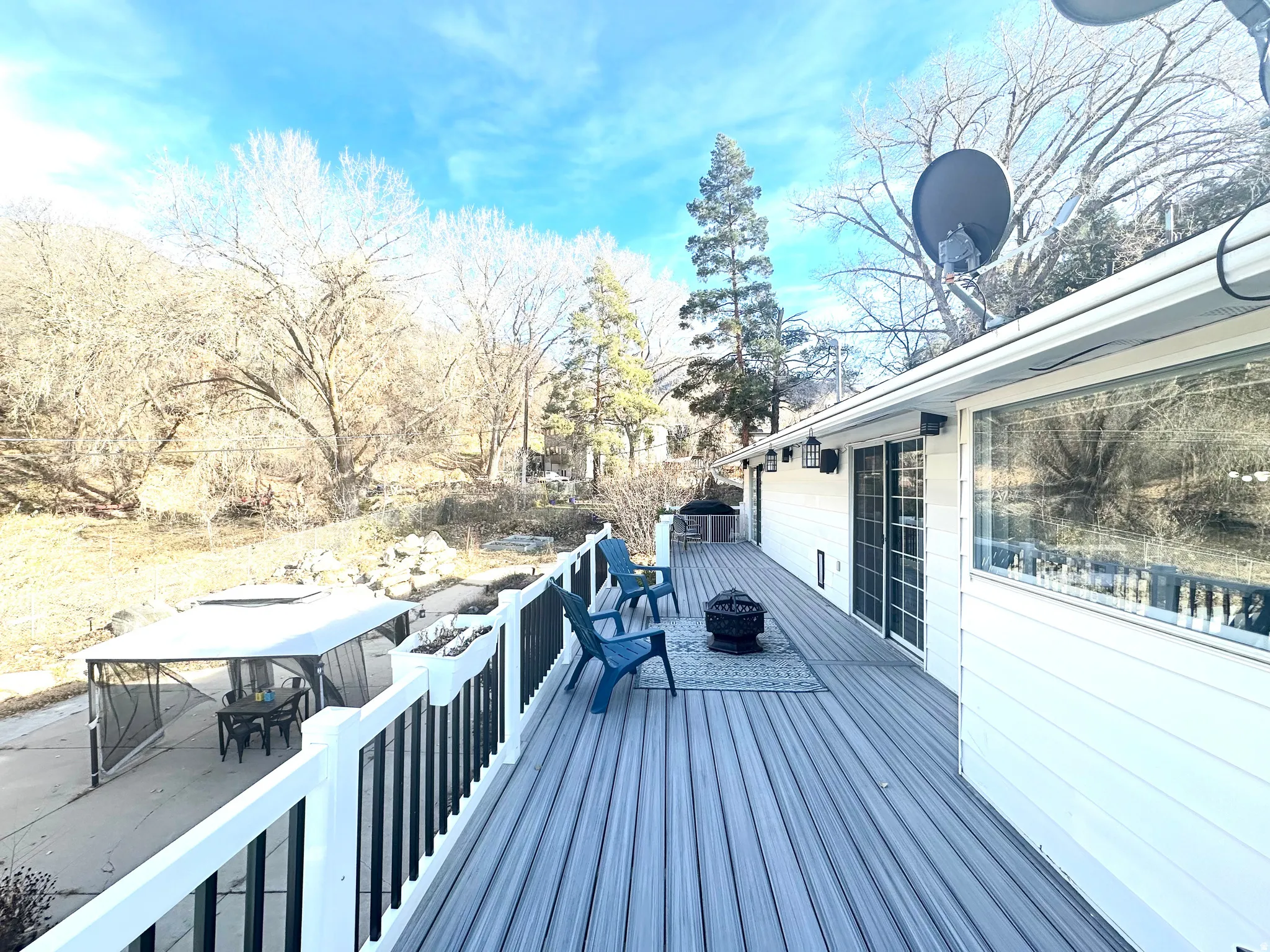 Wooden deck with an outdoor fire pit and outdoor dining area