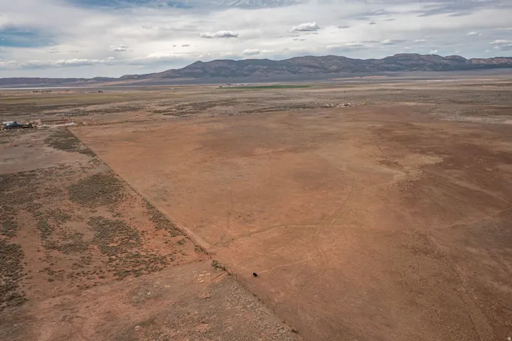 View of mountain backdrop with rural landscape and a desert landscape