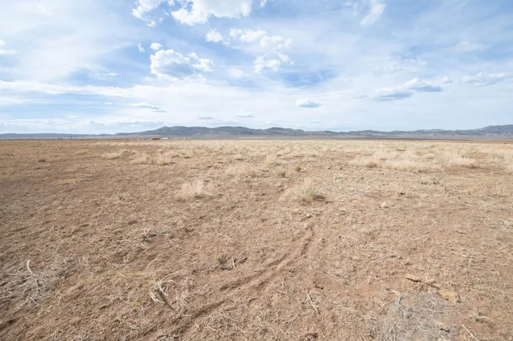 View of undeveloped land featuring mountains and rural landscape