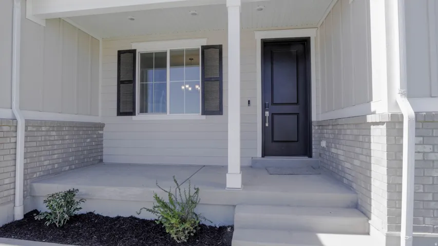 Entrance to property featuring covered porch and board and batten siding