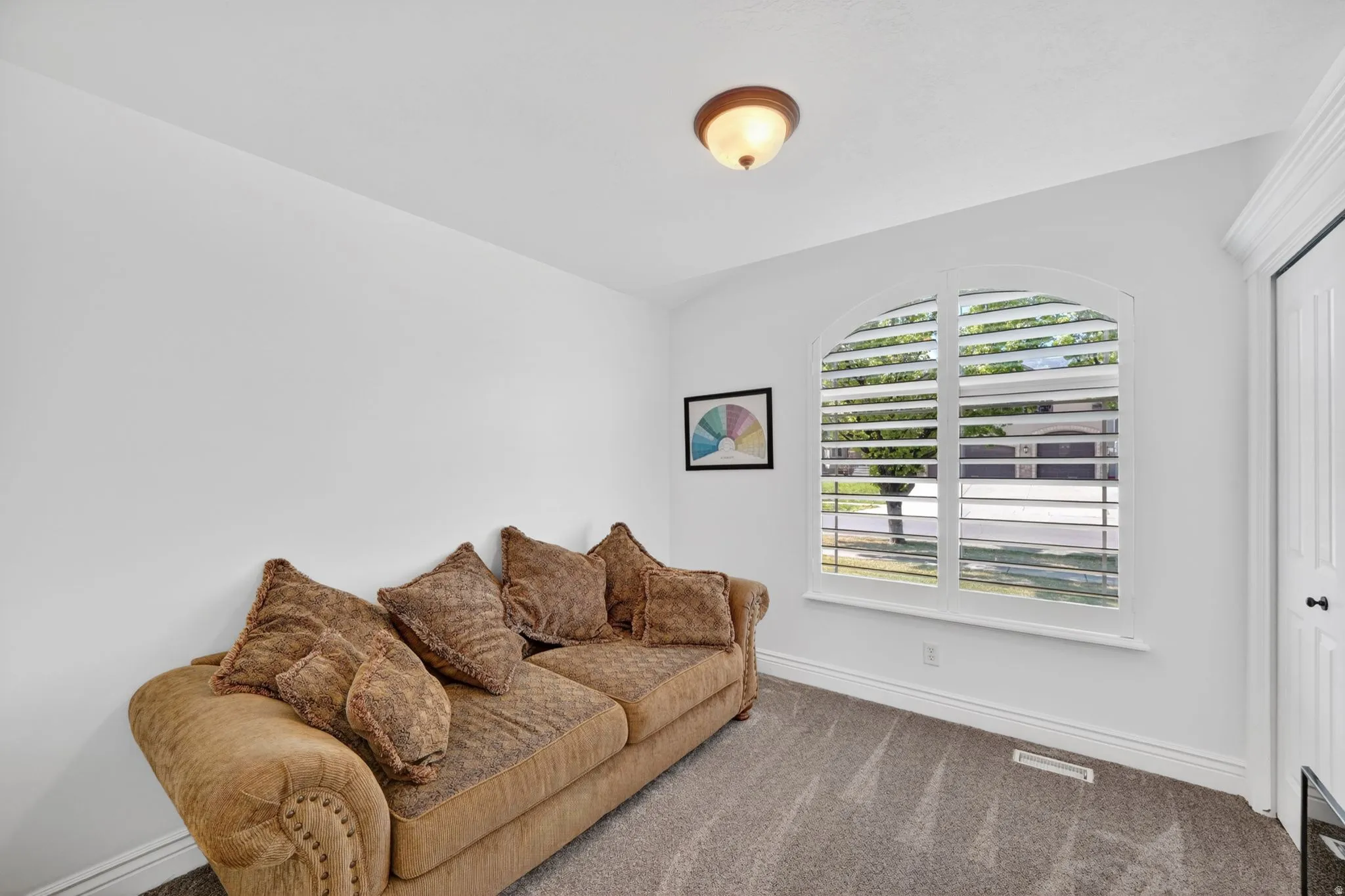 Living area with carpet and baseboards