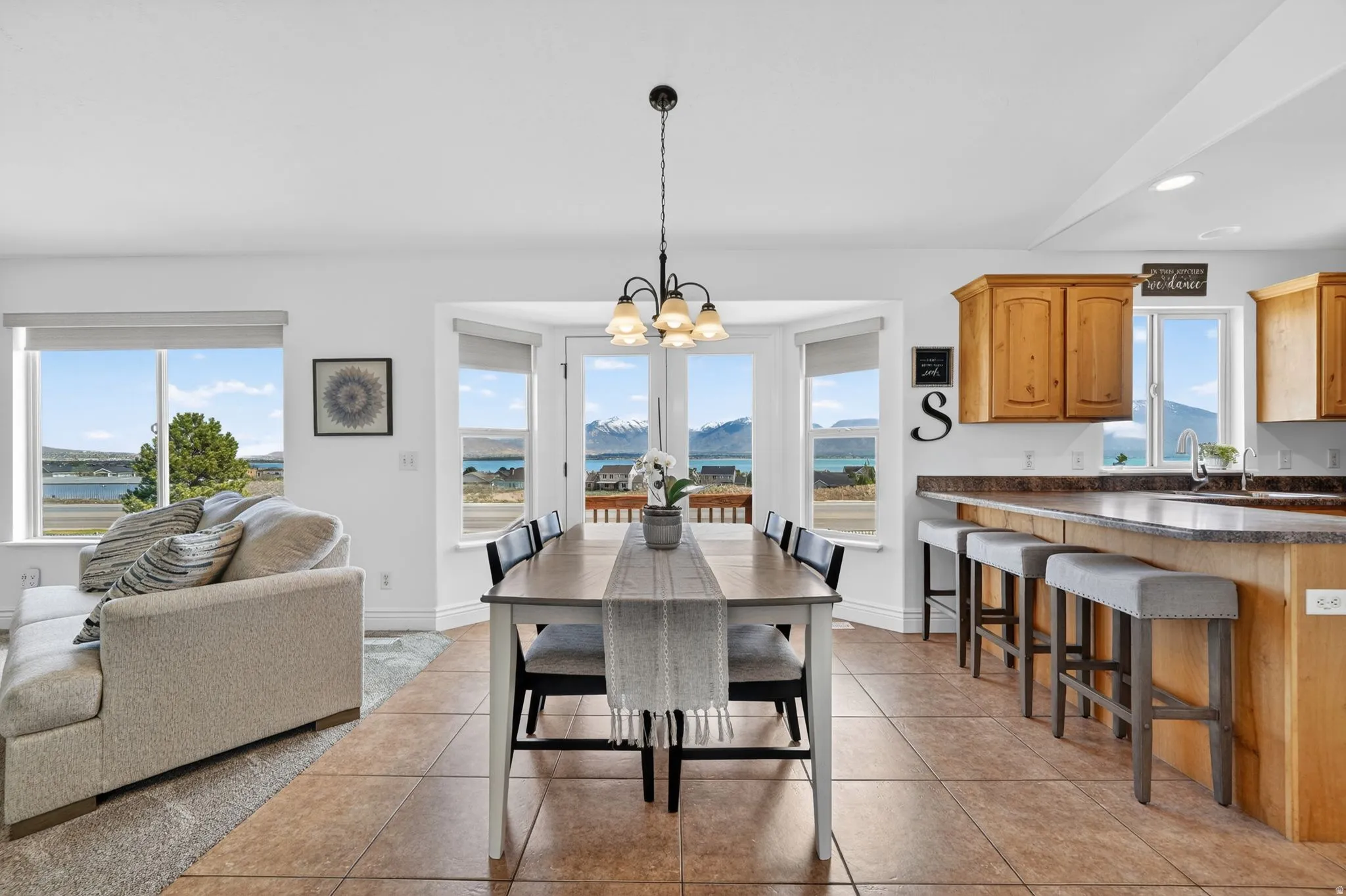 Dining area with hanging lights, a mountain view, and light tile patterned floors