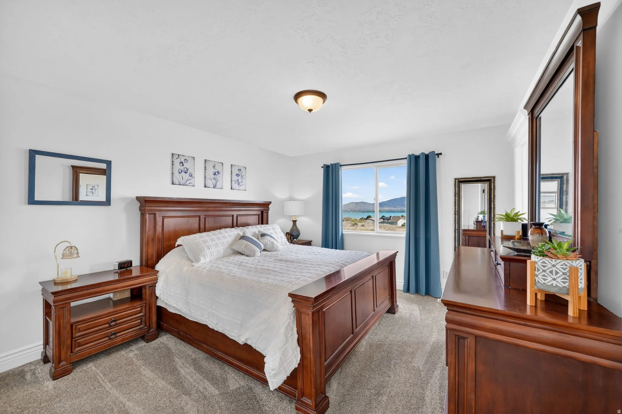 Carpeted bedroom featuring a mountain view and baseboards