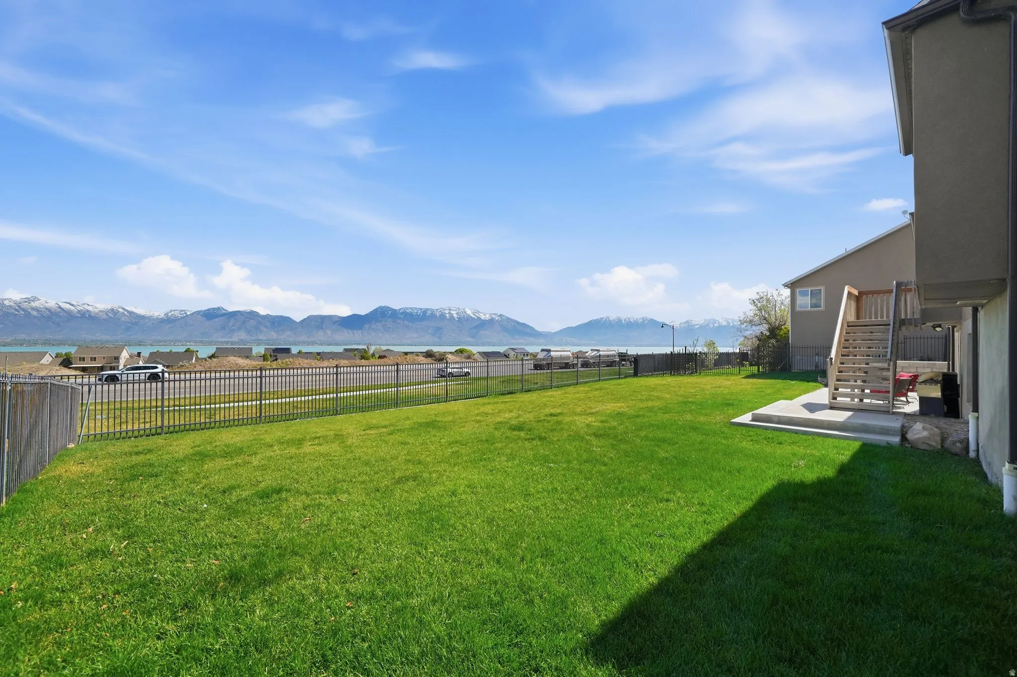 Fenced backyard featuring a mountain view and a patio