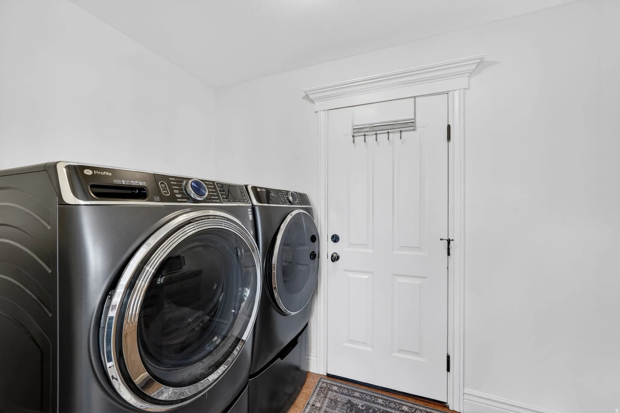 Laundry area featuring washer and clothes dryer and baseboards