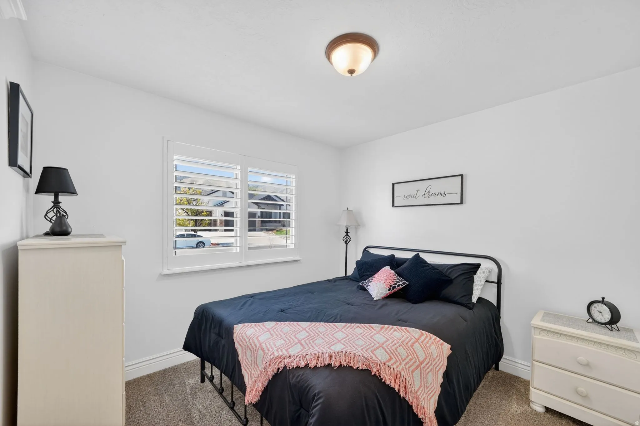 Carpeted bedroom featuring baseboards