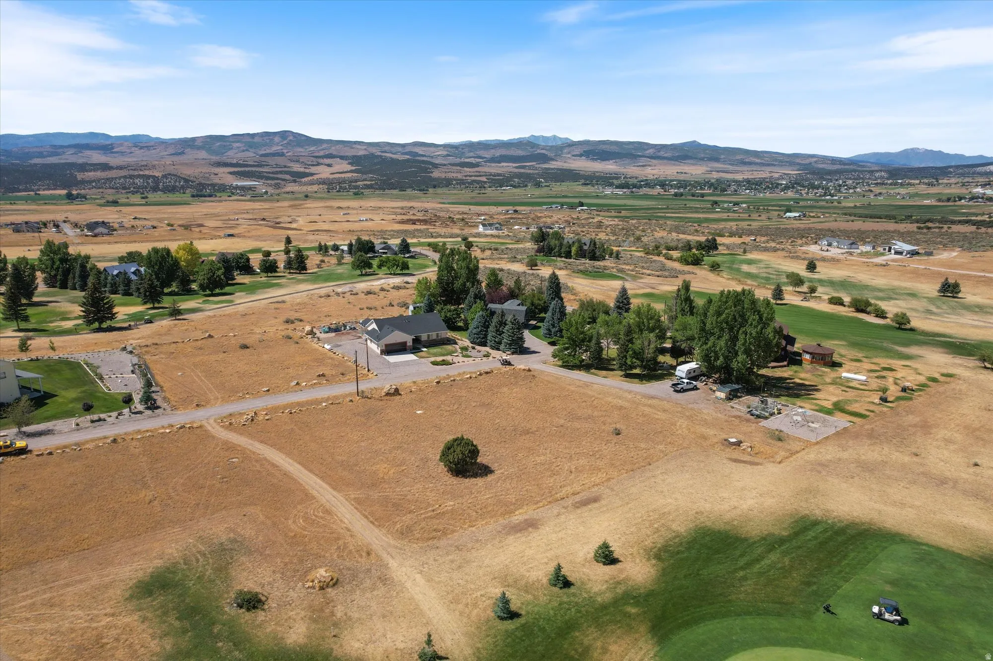 Aerial overview of property's location featuring a mountainous background and rural landscape