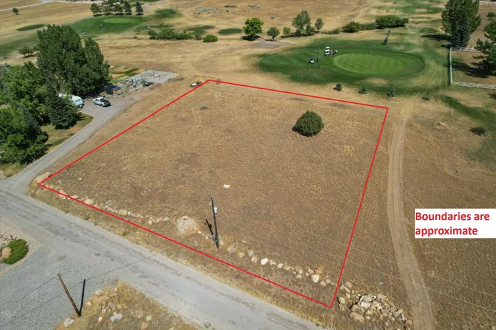 Aerial view of property and surrounding area with property parcel outlined and a golf club