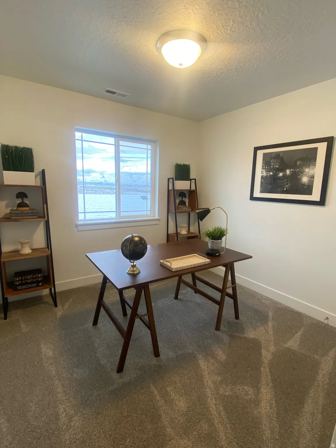 Office space featuring dark colored carpet and a textured ceilingPhotos of Dixon Model Home for reference only. Finishes may vary from photos shown.
