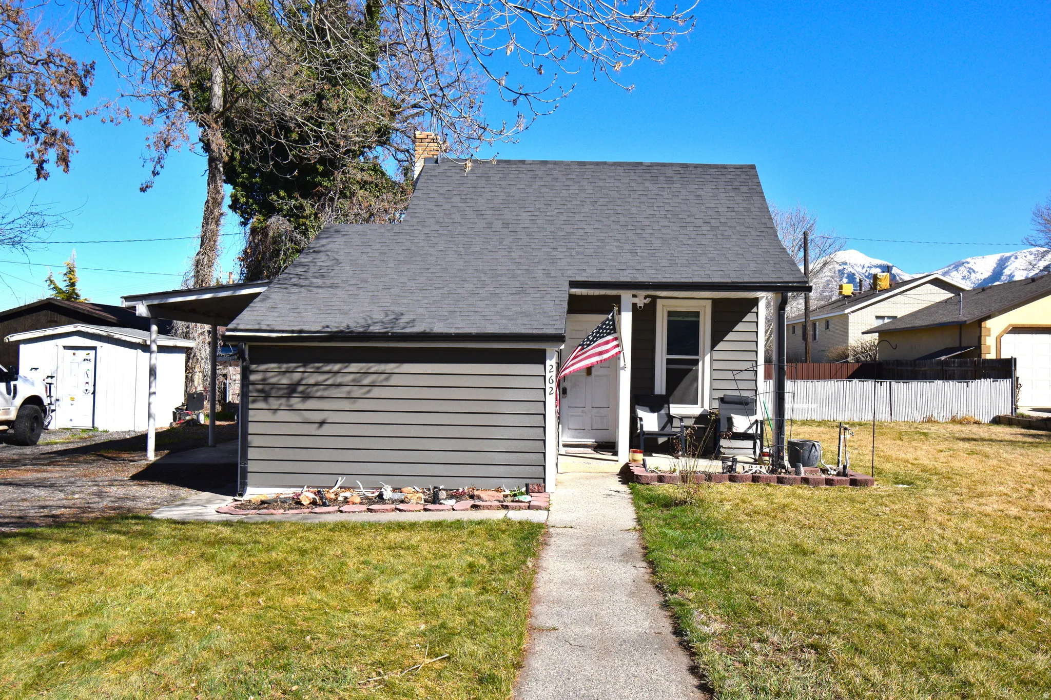View of front facade featuring roof with shingles and a porch